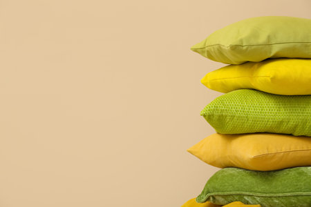 Stack of cushions near beige wall in roomの写真素材