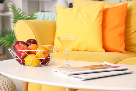 Summer cocktail with fruit basket and magazines on table in living room, closeupの写真素材