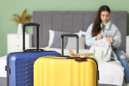 Suitcases and young woman at home. Travel conceptの写真素材