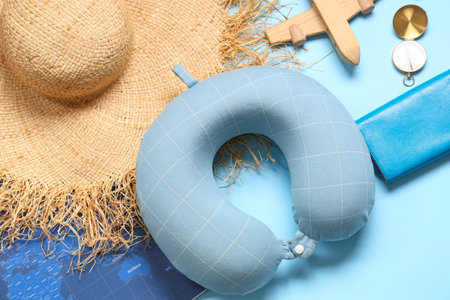Travel pillow, wallet and beach accessories on blue background, closeupの写真素材