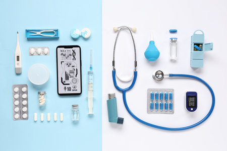 Mobile phone with medical supplies on blue and white background. Telemedicine conceptの写真素材