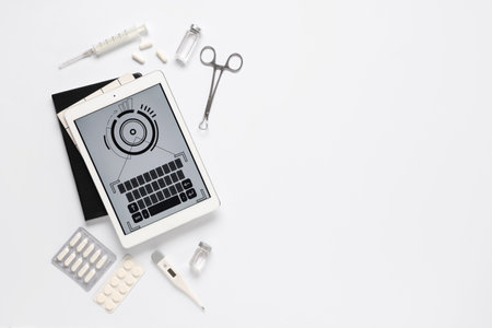 Tablet computer and medical supplies on white background. Telemedicine conceptの写真素材