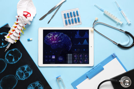 Tablet computer with medical supplies on blue background. Telemedicine conceptの写真素材