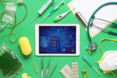 Tablet computer and medical supplies on green background. Telemedicine conceptの写真素材