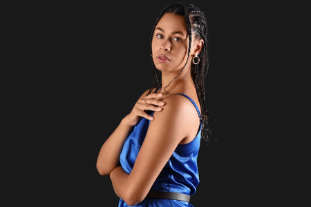 Beautiful African-American woman with dreadlocks on dark backgroundの写真素材
