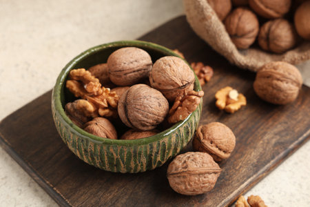 Bowl with tasty walnuts and nutcracker on white backgroundの写真素材