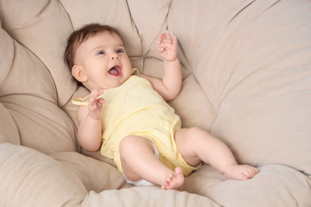 Cute little baby in armchair, closeupの写真素材