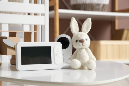 Baby monitor with toy bunny on table in children's bedroom, closeupの写真素材