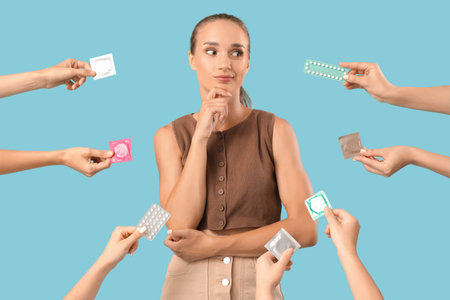 Thoughtful young woman and hands with contraceptives on blue background