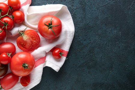 Tomatoes with white cloth on dark blue background. Top viewの写真素材