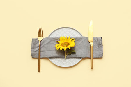 Beautiful table setting with sunflower on yellow backgroundの写真素材