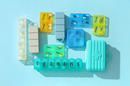 Plastic containers with pills on blue background. Top viewの写真素材