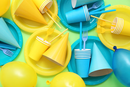 Composition with different disposable tableware and decor for birthday party on color backgroundの写真素材