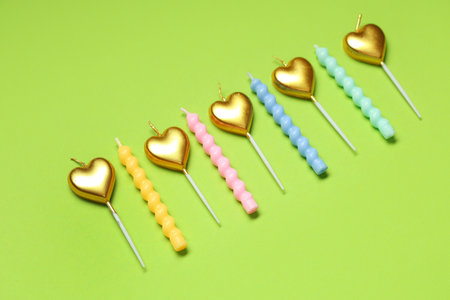 Different birthday candles on green backgroundの写真素材