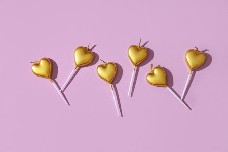 Birthday candles in shape of heart on lilac backgroundの写真素材