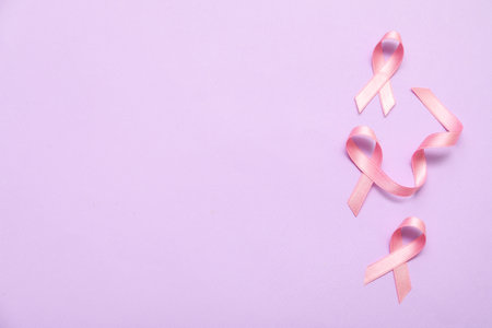 Pink silk ribbons on lilac background. Breast cancer conceptの写真素材