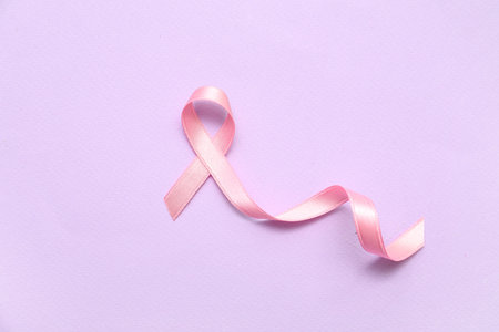 Pink silk ribbon on lilac background. Breast cancer conceptの写真素材