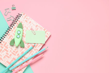 Rocket made of plasticine with stationery on colorful background. Top view