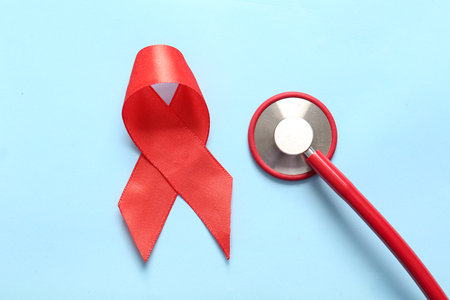 Red ribbon with stethoscope on blue background. Blood Cancer Awareness Monthの写真素材