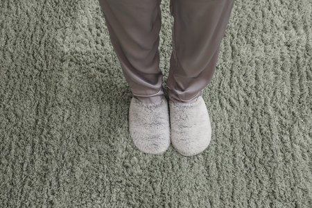 Woman in slippers standing on soft carpet. New beginning conceptの写真素材