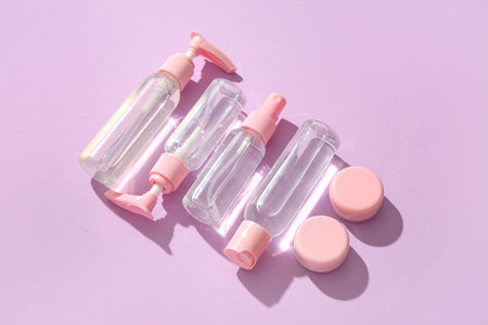Set of different travel cosmetic products on lilac backgroundの写真素材