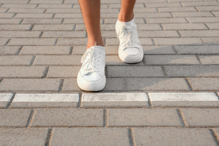 Man walking along paved road with starting line. Concept of new beginningの写真素材