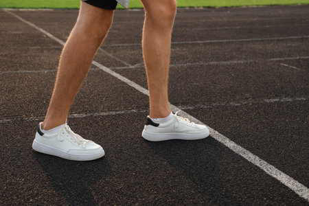 Male athlete in start position at stadium. Concept of new beginning