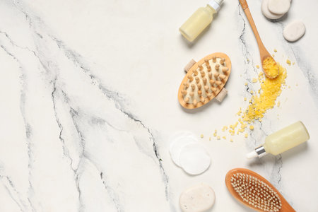 Composition with spa accessories and bottles of essential oil on light backgroundの写真素材