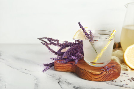Glass of fresh lavender lemonade with flowers on white backgroundの写真素材