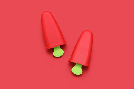 Ice cream molds on red backgroundの写真素材