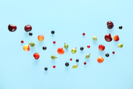 Different berries flying on blue backgroundの写真素材