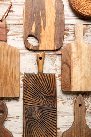 Different wooden cutting boards on white table