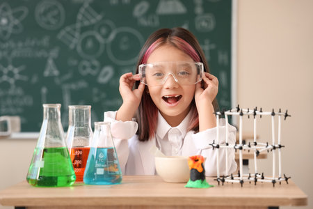 Cute little girl studying chemistry in science classroomの写真素材