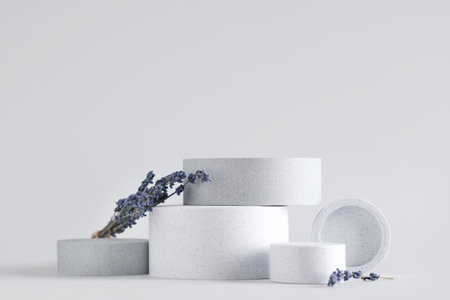 Decorative podiums with lavender flowers on gray backgroundの写真素材