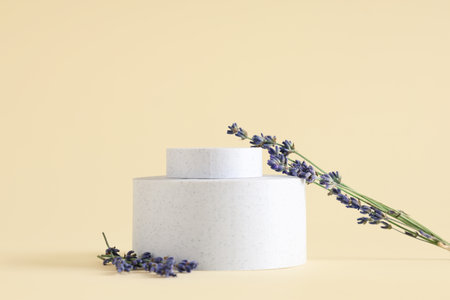 Decorative podiums with lavender flowers on yellow backgroundの写真素材