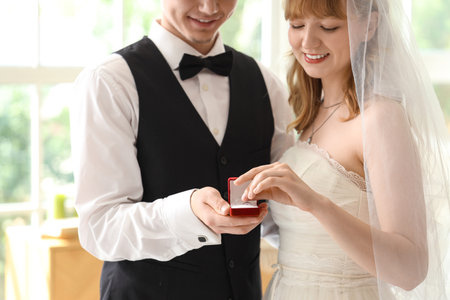 Young couple holding box with rings on their wedding day, closeupの写真素材