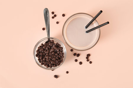 Glass of sweet chocolate milk on beige backgroundの写真素材