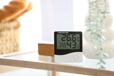 Digital hygrometer on shelf in room, closeupの写真素材