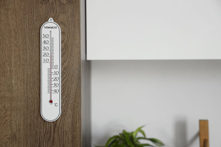 Home thermometer hanging in kitchen, closeup