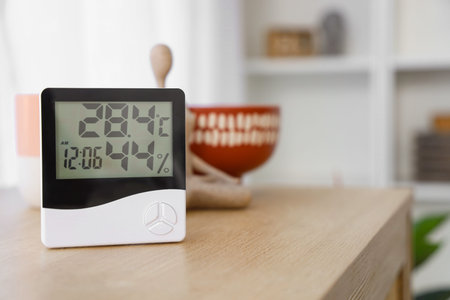Digital hygrometer on shelf in living room, closeup