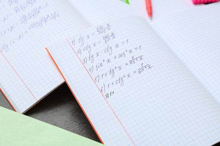 Open copybooks with math formulas, closeup