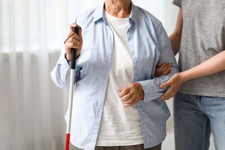 Young woman with blind grandmother at home, closeupの写真素材