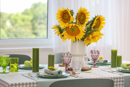 Vase with sunflowers on dining table in roomの写真素材