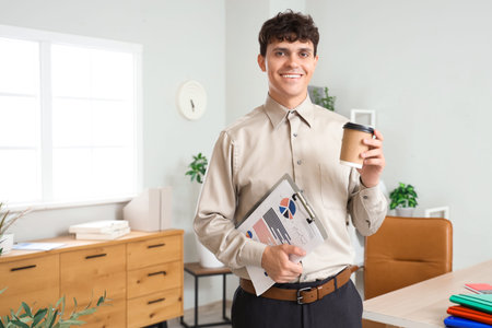 Male accountant with clipboard and cup of coffee in office