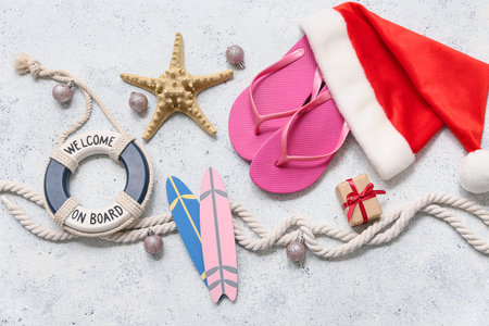 Santa's hat and beach accessories on white background. Top view