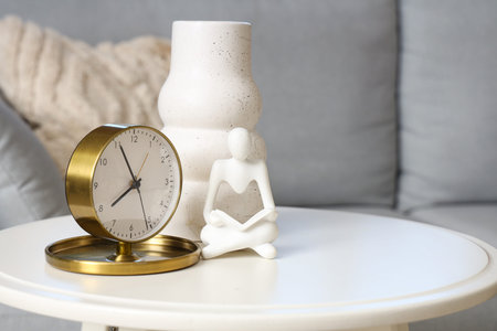Alarm clock with decor on table in living room, closeup