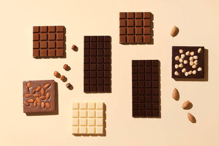 Composition with tasty chocolate bars and nuts on color background