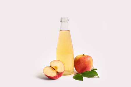 Bottle of fresh apple cider and fruits on white backgroundの写真素材