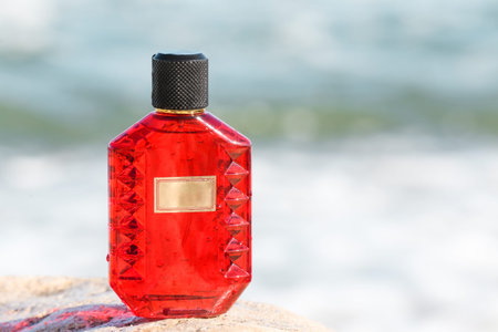 Bottle of perfume on stone near ocean, closeupの写真素材