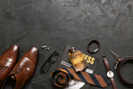 Set of male accessories with magazine, perfume and wrist watch on black background. Top viewの写真素材